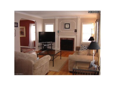 The inviting living room boasts hardwood floors, c