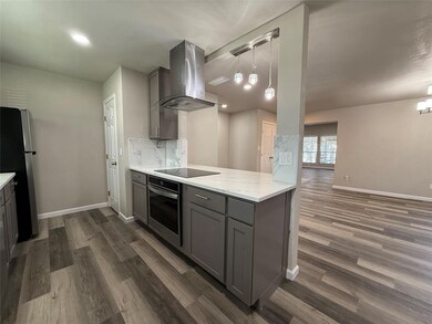 Kitchen featuring light stone counters, stainless 