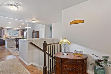 Welcoming entry with wood laminate flooring, dinin