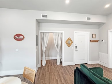 Entryway with wood finished floors and baseboards