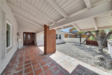 Huge Private Courtyard Entry with Covered Paver Walkway to Custom Entry Door with Beveled Glass and Matching Sidelights