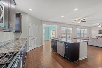 Kitchen featuring sink, a kitchen island with sink