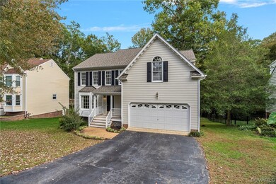 View of front of home featuring a front yard, a po