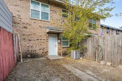 Property entrance featuring brick siding