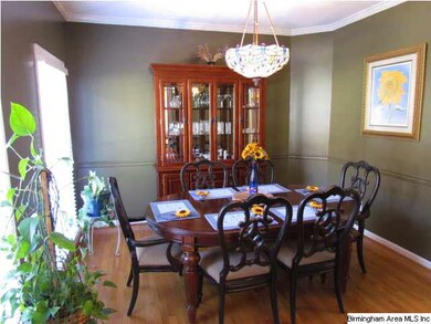 Large Dining Room with crown molding, large window
