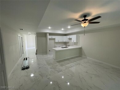 Kitchen with white cabinetry, visible vents, reces