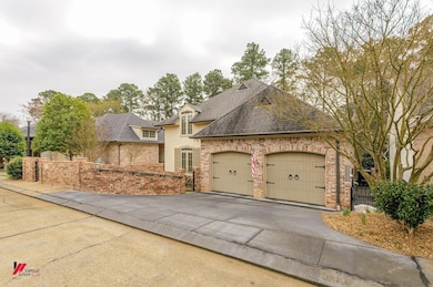 French country home featuring a garage, driveway, 