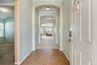 An inviting entryway sets the tone with arched doo
