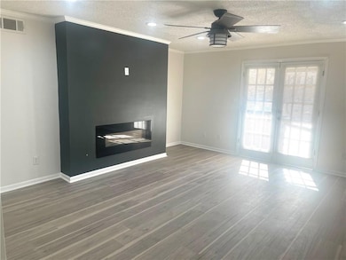 Unfurnished living room with visible vents, a text
