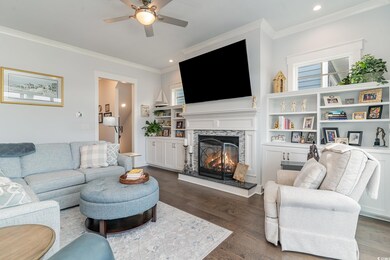 Living room featuring ceiling fan, dark wood-type 