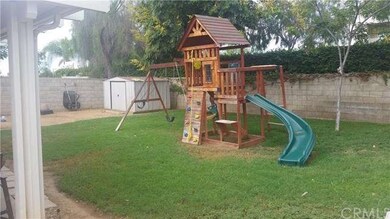 Wood play set and shed for storage.