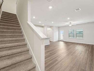 Stairs with recessed lighting, ceiling fan, wood 
