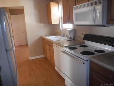 Kitchen view to laundry area and large closet and 1/2 bath beyond