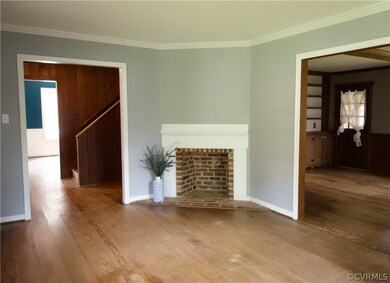 Living room with crown molding accessible from the