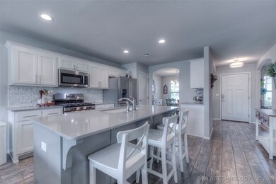 GAS range, quartz countertops, wood-look tile
