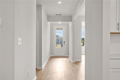 Foyer entrance with light hardwood / wood-style fl