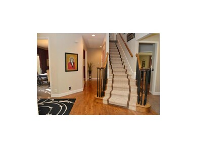 Beautiful curved staircase and hardwood flooring a