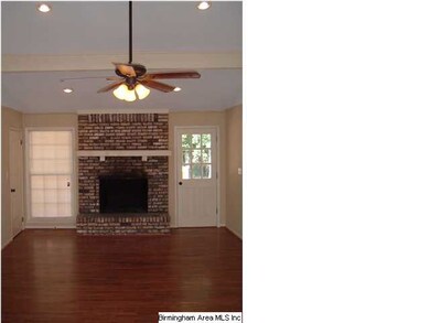 Hardwoods in the family room with soaring faulted 