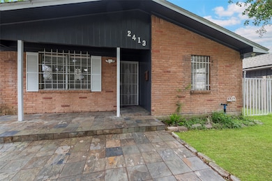 Charming brick home with a covered entryway, featu