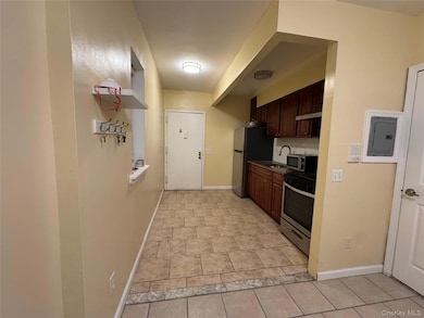 Kitchen featuring dark brown cabinets, stainless steel appliances, electric panel, and under cabinet range hood