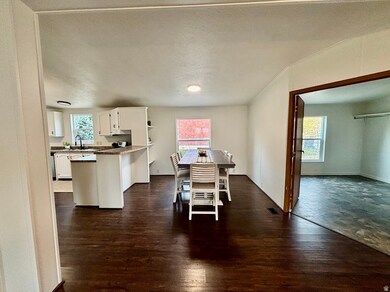 Dining space with dark wood finished floors and a textured ceiling
