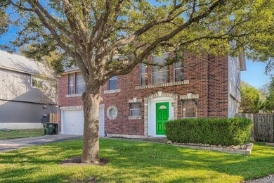 View of front of home featuring brick siding, dri