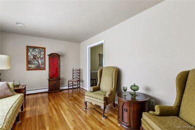 Living area featuring light hardwood floors and ba