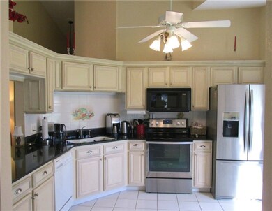 Updated kitchen with black granite counter tops an