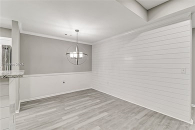 Unfurnished dining area featuring hardwood / wood-