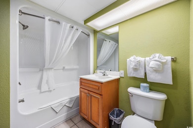 Full bathroom with tile patterned flooring, shower