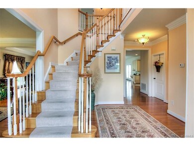 Two story foyer with hardwood floors.