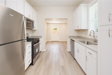 Kitchen with stainless steel appliances, a sink, l