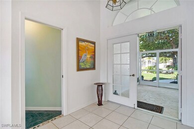 Foyer with light tile patterned flooring, a notabl
