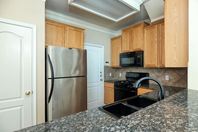 Kitchen featuring black appliances, a sink, decor