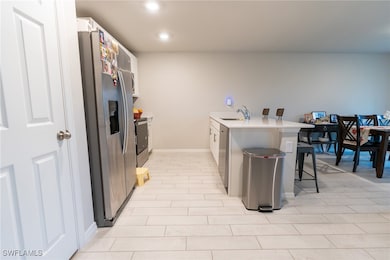 Kitchen featuring sink, white cabinetry, a kitchen