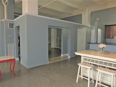 The bedroom has a large opening to the dining room