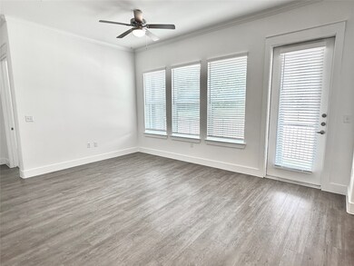 Large windows and 10 ft ceilings with crown moldin