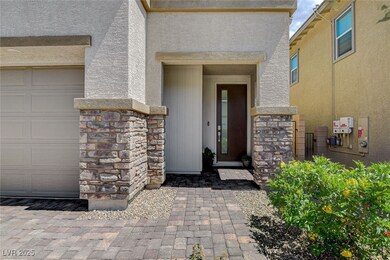View of exterior entry with stone siding and stucc