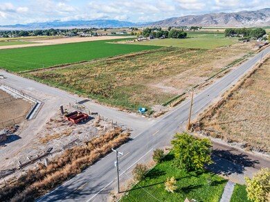 View of rural area featuring a mountainous background and extensive farmland