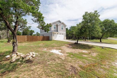 View of front of house with driveway, board and b