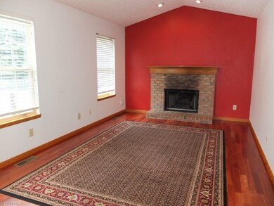 Family room with fireplace, vaulted ceiling and ha