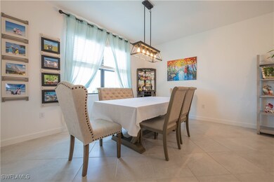Dining space with baseboards and light tile patter