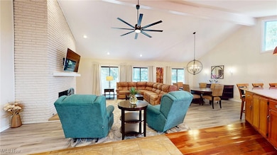Living room with plenty of natural light, high vaulted ceiling, luxury vinyl flooring,