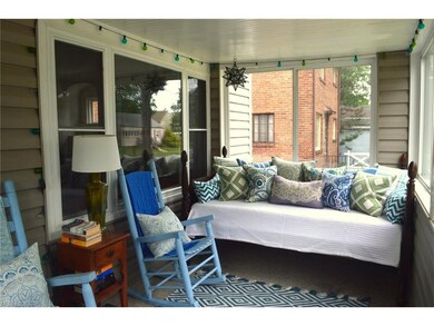 Charming enclosed front porch offers additional li