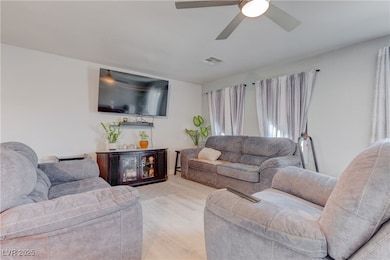 Living room with light wood-type flooring and ceil