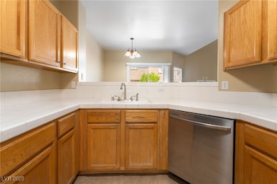 Kitchen with dishwasher, a sink, and decorative ba