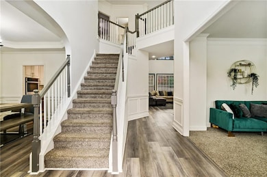 Stairway with a wainscoted wall, a decorative wall