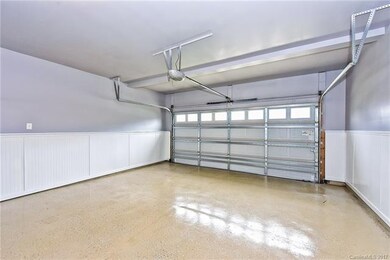 2-car garage with painted walls, beadboard wainsco