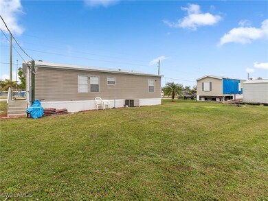 Rear view of property featuring a yard and central