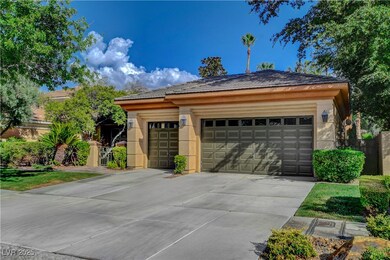 View of front of home with a garage, concrete driveway, an outdoor structure, and stucco siding